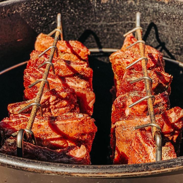 The Rib Hanger Kit in use with 12 racks of pork ribs cooking in a 55 gallon Gateway Drum Smoker