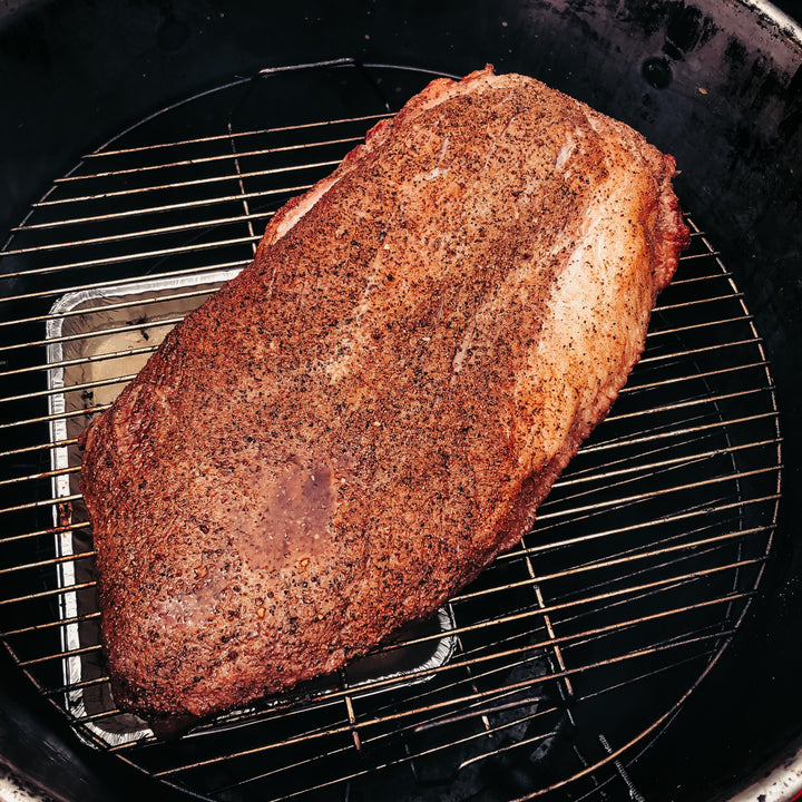 A full packer brisket being cooked using the 55 gallon cooking grate in a Gateway Drum Smoker